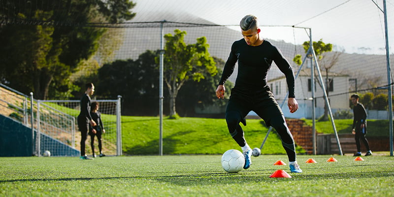 Cover photo of article depicting a soccer player on the field